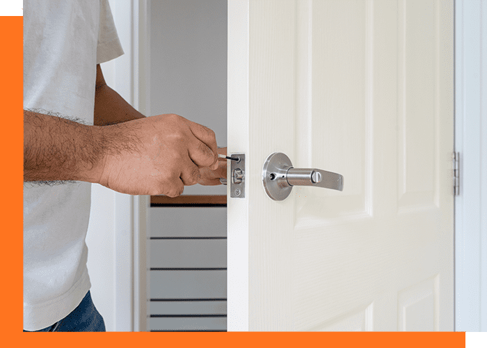 locksmith in white shirt fix white wood door by screwdriver for service concept